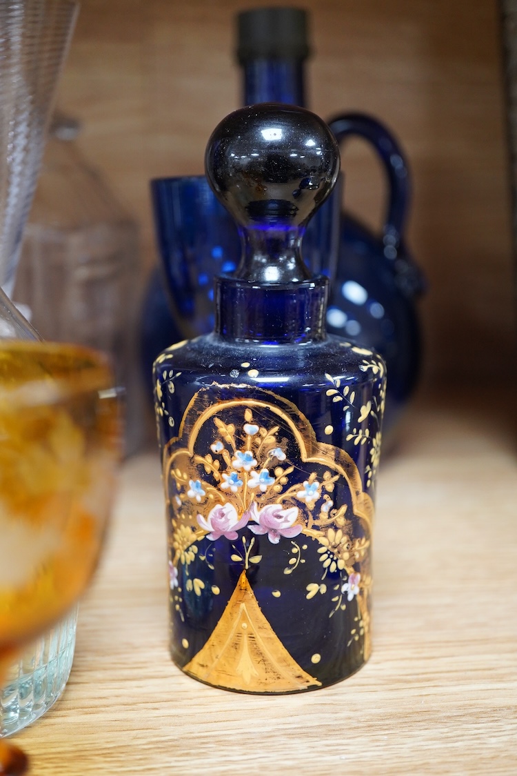 A collection of coloured glass flagons, glasses and bottles etc. (18). Tallest decanter and stopper 25cm high.